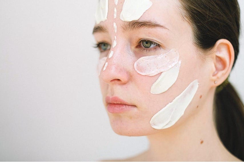 Credit: Pexels | Anna Shvets - Woman applying skincare to face.